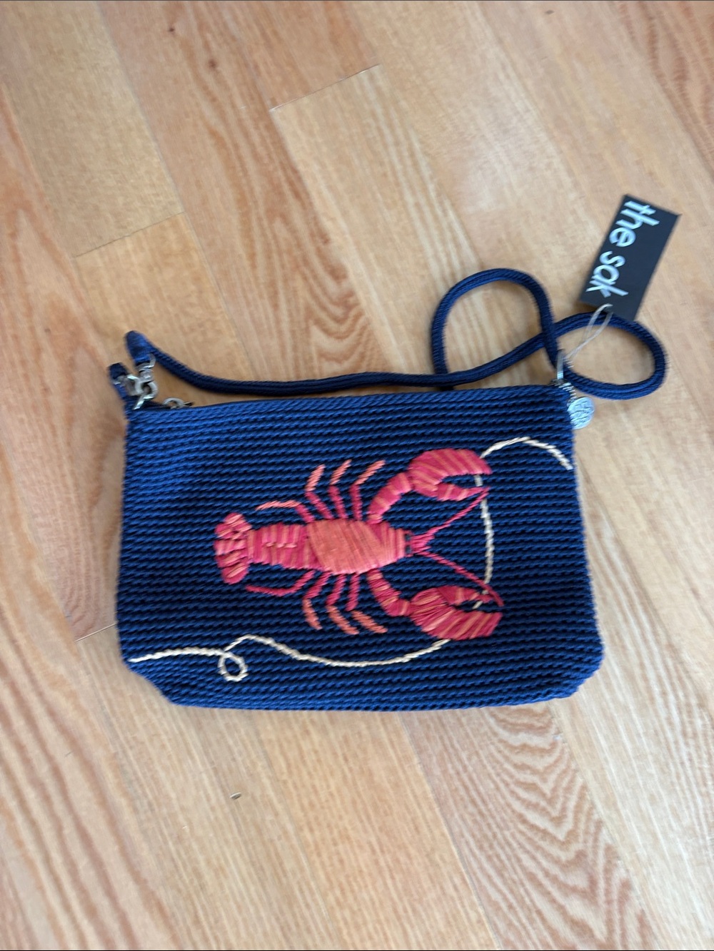 The Sak Navy Wristlet with Red Lobster Embroidery